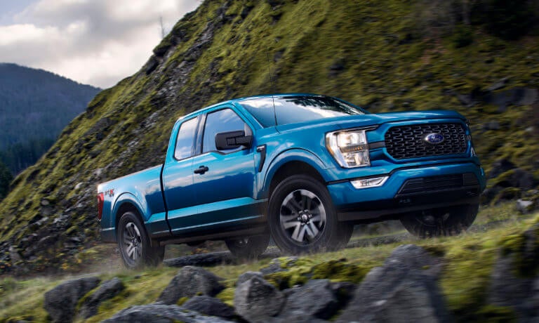 2022 Ford F-150 driving on grassy mountainside