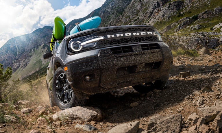 2025 Ford Bronco Sport driving up road with kayaks