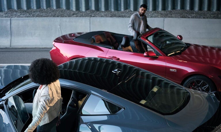 2025 Ford Mustang pair parked by concrete wall