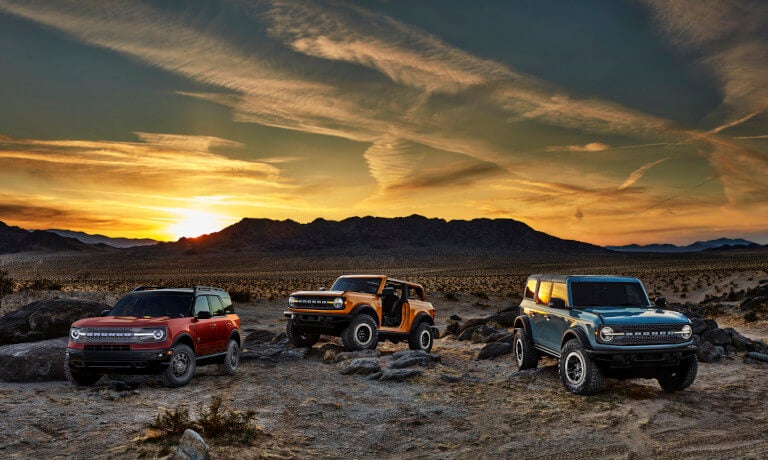 2026 Ford Bronco lineup parked in desert at sunset