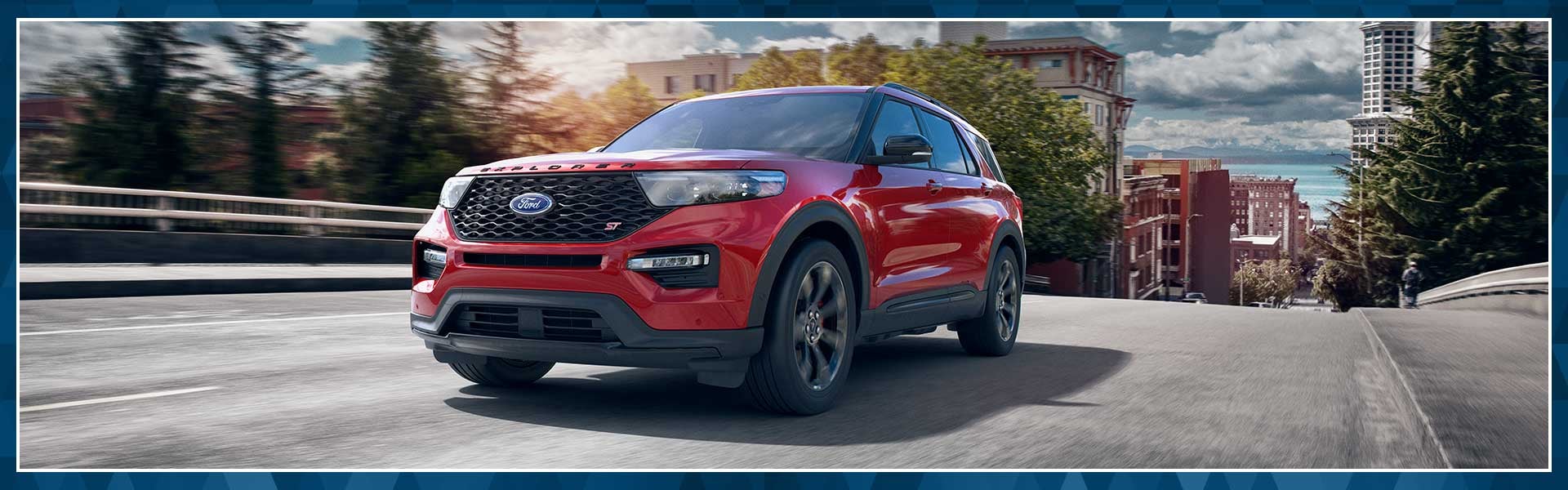 A red 2022 Ford Explorer driving down the street