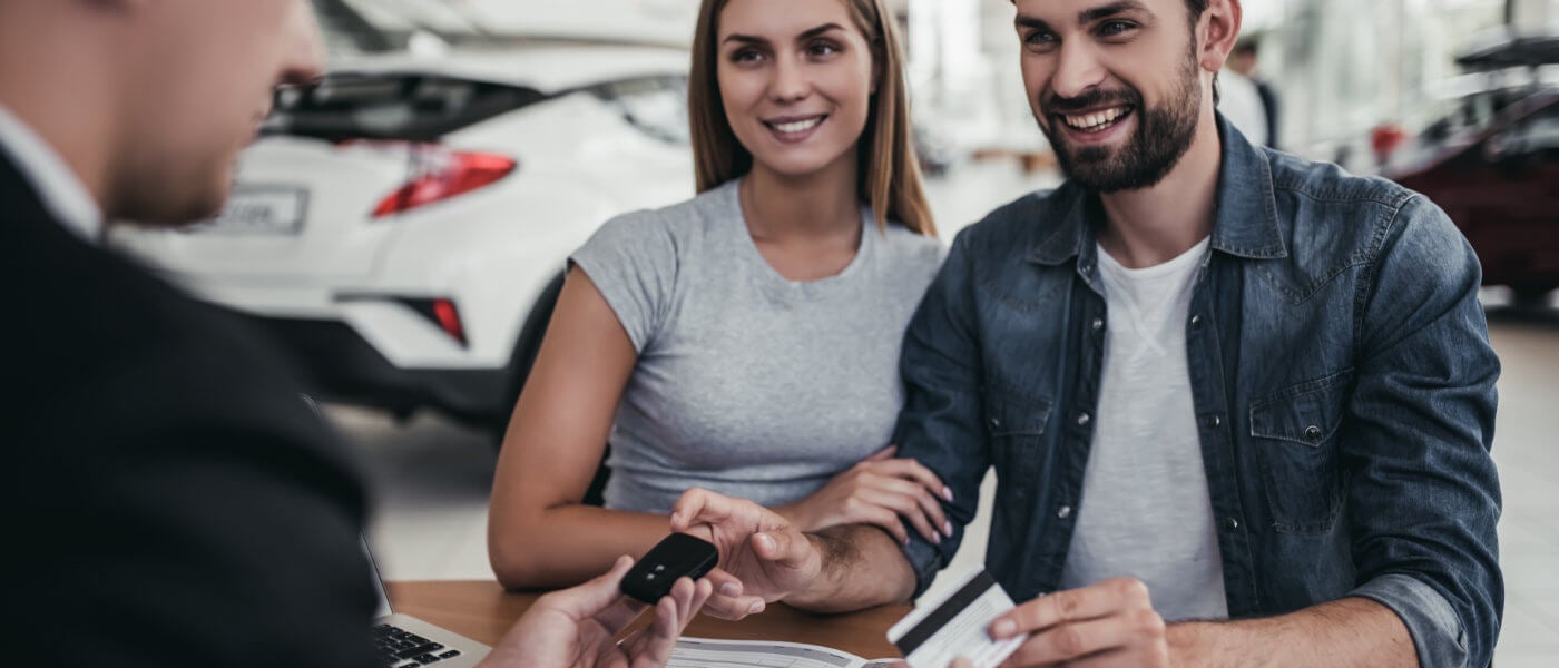Young couple being handed keys