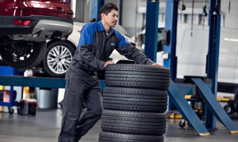 Ford technician moving tires