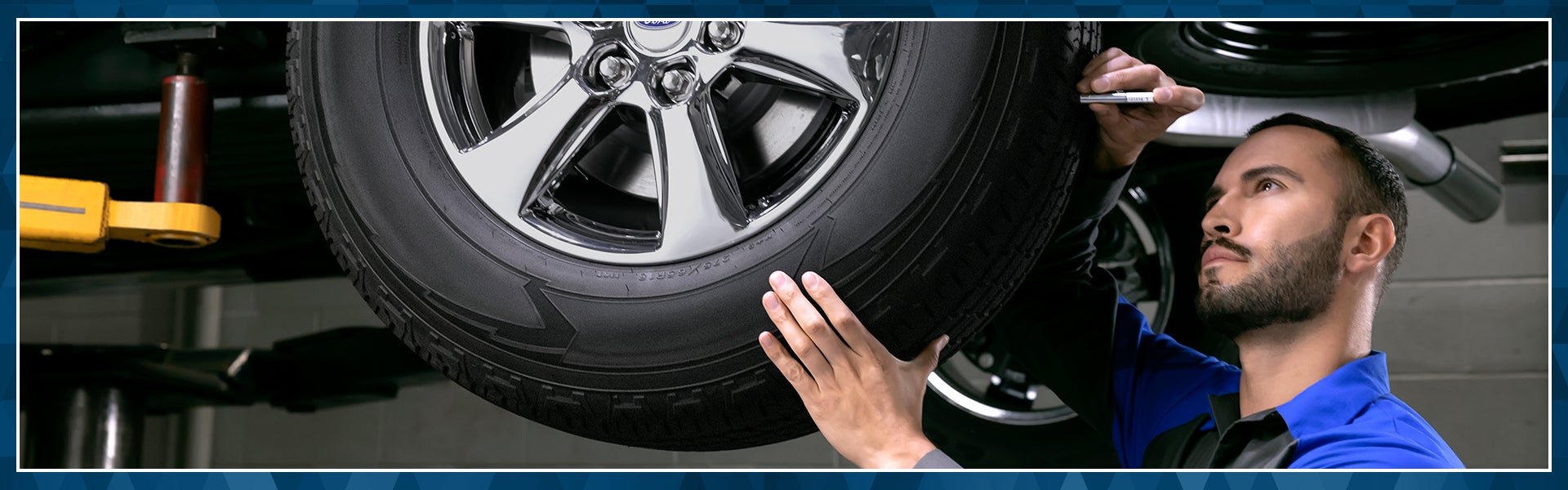An auto technician performing Ford service