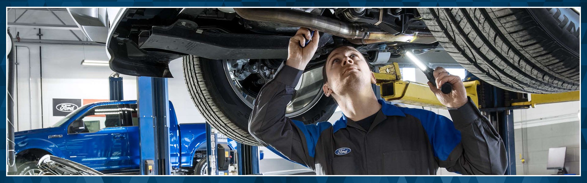 Ford technician looking under a vehicle