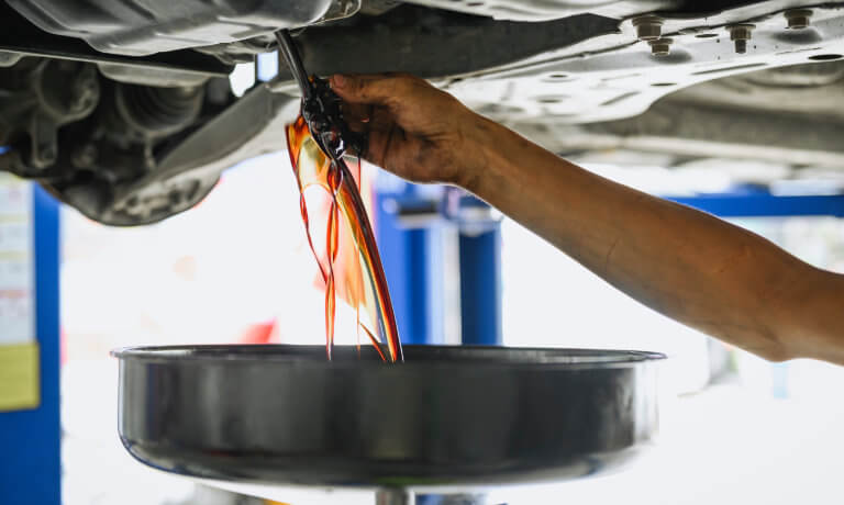 Oil draining from under car